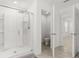 Bright bathroom featuring a glass-enclosed shower and open doorway to toilet room at 5226 Mahogany Dr, Mount Dora, FL 32757
