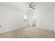 Bright bedroom with plush carpet, a ceiling fan, and an attached bathroom at 5226 Mahogany Dr, Mount Dora, FL 32757