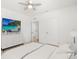 Bright bedroom featuring a sleek ceiling fan, a TV, and neutral decor at 5226 Mahogany Dr, Mount Dora, FL 32757