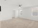Bright bedroom with neutral carpet, ceiling fan, and lots of natural light from two windows at 5226 Mahogany Dr, Mount Dora, FL 32757