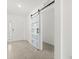 Bright foyer with a modern sliding barn door and tile flooring at 5226 Mahogany Dr, Mount Dora, FL 32757