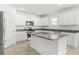 Bright kitchen features white cabinetry, stainless steel appliances, a kitchen island, and tile flooring at 5226 Mahogany Dr, Mount Dora, FL 32757