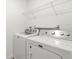 Laundry room with Maytag washer and dryer, with wire shelf at 5226 Mahogany Dr, Mount Dora, FL 32757