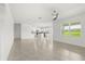 Bright open concept living room features tile floors and a view of the eat-in kitchen at 5226 Mahogany Dr, Mount Dora, FL 32757