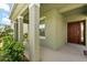 Inviting covered front porch with modern columns and a stylish entryway at 5226 Mahogany Dr, Mount Dora, FL 32757
