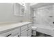 Clean bathroom with white vanity, shower and tub combination featuring modern fixtures and neutral tones at 5263 Images Cir # 306, Kissimmee, FL 34746