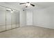 A spacious bedroom features carpet, ceiling fan, and mirrored closet doors at 5263 Images Cir # 306, Kissimmee, FL 34746