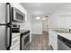 Bright kitchen with stainless steel appliances, white cabinets, and wood floors at 5263 Images Cir # 306, Kissimmee, FL 34746