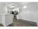 Modern kitchen with white cabinets and stainless steel appliances with wood floors open to living room at 5263 Images Cir # 306, Kissimmee, FL 34746