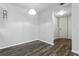 Bright living room features wood flooring and a modern light fixture at 5263 Images Cir # 306, Kissimmee, FL 34746