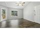 Bright living room with wood floors, neutral paint, and a window overlooking the community at 5263 Images Cir # 306, Kissimmee, FL 34746