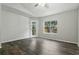 Light filled living room with wood floors, neutral paint, and a door leading to balcony at 5263 Images Cir # 306, Kissimmee, FL 34746