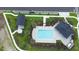 Aerial view of a community pool and amenities center, surrounded by lush landscaping and walkways at 5310 Teirgarten St, St Cloud, FL 34771