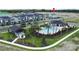 Community aerial view highlighting a pool area, amenities center, and surrounding residential homes at 5310 Teirgarten St, St Cloud, FL 34771