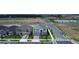 Overhead shot of home, showcasing roof, yard, neighborhood streets, and nearby open land in a developing area at 5310 Teirgarten St, St Cloud, FL 34771
