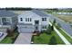Stunning aerial view of a two-story home with a paver driveway, lush landscaping, and a well-manicured lawn at 5310 Teirgarten St, St Cloud, FL 34771