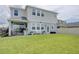 Spacious backyard with well-maintained lawn, cozy patio seating, and a view of the home's exterior at 5310 Teirgarten St, St Cloud, FL 34771