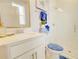 Well-lit bathroom featuring a quartz countertop vanity, white cabinetry, and glass-enclosed shower at 5310 Teirgarten St, St Cloud, FL 34771
