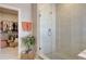 Walk-in closet connected to bathroom features a glass shower with tile surround and storage shelving at 5310 Teirgarten St, St Cloud, FL 34771
