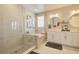 Bright bathroom featuring glass enclosed shower, soaking tub, double sink vanity, and tile flooring at 5310 Teirgarten St, St Cloud, FL 34771