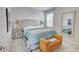 Comfortable bedroom showcasing a tufted headboard, neutral color scheme, and stylish bench at 5310 Teirgarten St, St Cloud, FL 34771