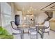 Dining area view to the modern kitchen with island and bar seating, bright with natural light at 5310 Teirgarten St, St Cloud, FL 34771