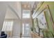 Stunning two-story foyer with elegant chandelier, decorative accents, and abundant natural light at 5310 Teirgarten St, St Cloud, FL 34771