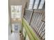 Stylish foyer features chandelier, staircase, white tile flooring, and large window with outside view at 5310 Teirgarten St, St Cloud, FL 34771