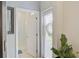 Bright hallway leading to a bathroom with a glass-enclosed shower and a sunlit window at 5310 Teirgarten St, St Cloud, FL 34771