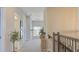 Hallway view highlights the staircase, neutral carpet, and natural lighting enhancing the home's ambiance at 5310 Teirgarten St, St Cloud, FL 34771