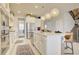 Spacious kitchen featuring white cabinetry, stainless steel appliances, and an island with seating at 5310 Teirgarten St, St Cloud, FL 34771