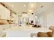 Bright, modern kitchen with white cabinets, gold hardware, and a stylish island with pendant lighting at 5310 Teirgarten St, St Cloud, FL 34771