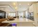 Kitchen island with white countertop, seating, modern pendant lights, and stainless steel appliances at 5310 Teirgarten St, St Cloud, FL 34771