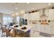 Bright kitchen with island and stainless appliances, featuring seating and open-concept dining at 5310 Teirgarten St, St Cloud, FL 34771