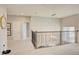 Bright carpeted living room features rod iron railings, a hanging light fixture, and white doors at 5310 Teirgarten St, St Cloud, FL 34771