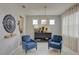 Serene living room with neutral tones, stylish armchairs, decorative accents, and archway to another room at 5310 Teirgarten St, St Cloud, FL 34771