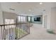 Spacious loft area with neutral colors, a comfortable seating area, and natural light at 5310 Teirgarten St, St Cloud, FL 34771