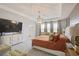 Spacious main bedroom features a tray ceiling, a decorative light fixture, and carpeted floors at 5310 Teirgarten St, St Cloud, FL 34771