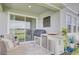 Inviting outdoor patio features a built-in grill, woven seating, and sliding glass doors to merge indoor/outdoor living at 5310 Teirgarten St, St Cloud, FL 34771