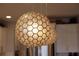 Close up of unique pendant lights that adorn the kitchen island at 5310 Teirgarten St, St Cloud, FL 34771