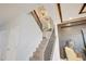 Elegant staircase featuring wood steps, iron railings, and contemporary lighting fixtures at 5310 Teirgarten St, St Cloud, FL 34771