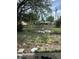 Wide backyard featuring a wood fence and partial tree coverage at 6308 Stanwin Dr, Apopka, FL 32712