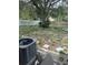Spacious backyard featuring a large tree, partial fence, and AC unit at 6308 Stanwin Dr, Apopka, FL 32712