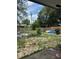 Large backyard area with a wood fence and view of neighborhood trees at 6308 Stanwin Dr, Apopka, FL 32712