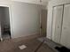 An empty bedroom with neutral walls, brown carpet, closet, and door at 6308 Stanwin Dr, Apopka, FL 32712