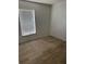 Bright bedroom with wood-style flooring and a window with blinds at 6308 Stanwin Dr, Apopka, FL 32712