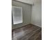 An inviting bedroom with neutral walls, wood flooring, and a window for natural light at 6308 Stanwin Dr, Apopka, FL 32712