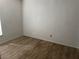 Simple bedroom with wood-style flooring and a window providing natural light at 6308 Stanwin Dr, Apopka, FL 32712