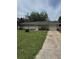 Single story home with well kept lawn, single car garage, and a tidy landscape with a tree in the front at 6308 Stanwin Dr, Apopka, FL 32712