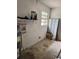 A spacious garage interior with block walls, a window, and ample room for storage and projects at 6308 Stanwin Dr, Apopka, FL 32712